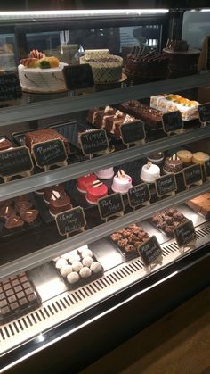 a display case filled with lots of different types of cakes