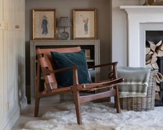 a living room filled with furniture and a fire place next to a white fireplace mantel