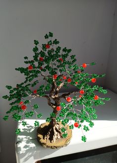 a bonsai tree with red and green leaves