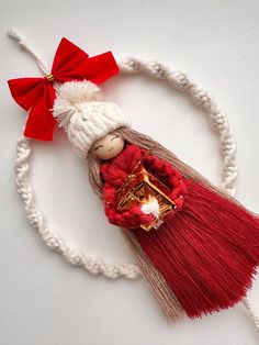 a red and white tasseled doll with a bell on it's head