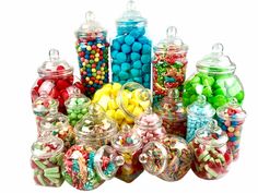 many different types of candy in glass jars