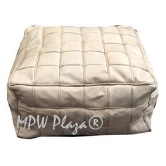 a white leather ottoman with the words hdw play on it's side