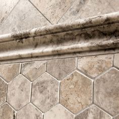 the corner of a marble tiled shower stall