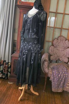 Black silk chiffon beaded Flapper dress, approx sizing from 4-8 (bias cut) Gown does include the matching beaded jacket. More pics on FB:https://www.facebook.com/pg/RetroVintageWeddings1920s1930s/photos/?tab=album&album_id=2623216997774327 Black Gatsby Style Embellished Dress, Elegant Floor-length Flapper Evening Dress, Elegant Formal Floor-length Flapper Dress, Elegant Floor-length Flapper Dress, Embellished Flapper Evening Dresses, Elegant Fitted Flapper Dress For Festive Occasions, Black Gatsby Style Formal Dress, Elegant Fitted Floor-length Flapper Dress, Black Flapper Dress For Formal Occasions