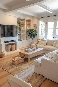 a living room filled with furniture and a flat screen tv mounted on a wall above a fire place