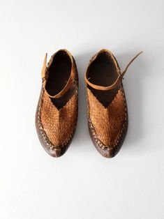 "This is a pair of vintage Turkish leather shoes. The hand-crafted woven leather shoes feature a classic pointed upturned, leather soles, and an ankle strap with buckle closure. Two tone coloring adds to their style. CONDITION In good condition with wear consistent with wear and use. APPROXIMATE FIT: Women's US 8 MEASUREMENTS Insole Length: 9.5\" .. 24.1 cm Outsole Length: 10.25\" .. 26 cm Width: 3.75\" .. 9.5 cm Height: 2.25\" .. 5.7 cm Circumference Ankle Strap: 12.5\" .. 31.8 cm 1120207" Woven Leather Shoes With Round Toe, Brown Woven Leather Shoes With Round Toe, Vintage Leather Shoes For Summer, Vintage Leather Shoes With Leather Sole For Summer, Leather Shoes With Woven Sole And Closed Toe, Woven Leather Shoes, Slipper Shoes Women, Hippie Boots, Vintage Hippie