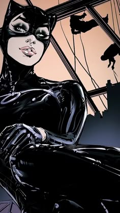 a woman in black cat suit sitting on top of a chair