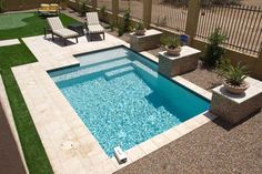 an empty swimming pool in the middle of a yard with lawn chairs and potted plants