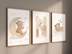 three wall hangings with teddy bears on them and the letter n in gold foil