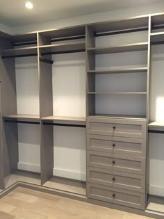 an empty walk in closet with shelves and drawers