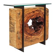 a piece of wood that has been turned into a table with glass top and metal frame