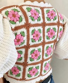 the back of a woman's sweater with flowers on it