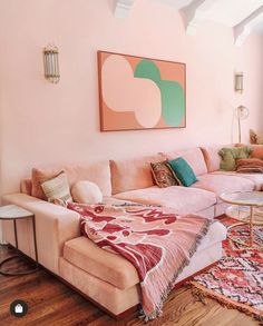 a living room filled with furniture and pink walls