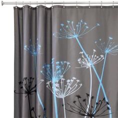 a shower curtain with dandelions painted on it in a bathroom setting that is blue and white