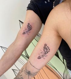 two people with matching tattoos on their arms