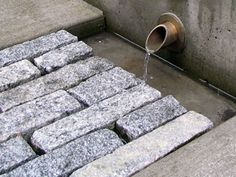 a pipe that is connected to some concrete blocks