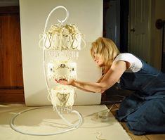 a woman working on a sculpture in a room