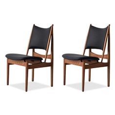 a pair of chairs with black leather seats