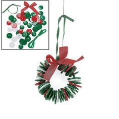 a christmas wreath ornament hanging from a string with red ribbon and green buttons