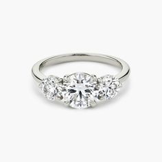 three stone diamond ring on white background