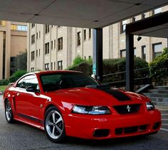 a red sports car parked in front of a building