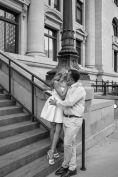 a man and woman are hugging on the steps