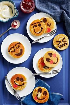 pancakes with smiley faces on them sitting on plates