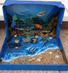 an ocean scene made out of cardboard and sand with sea animals on the bottom part