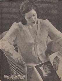 an old photo of a woman sitting at a table with a magazine in front of her