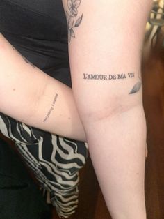 a woman with a tattoo on her arm that reads, lamour de ma vie