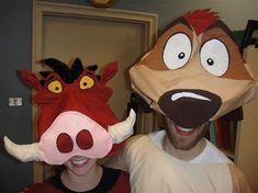 a man and woman are wearing animal masks