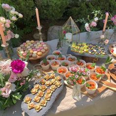 a table filled with lots of food and desserts