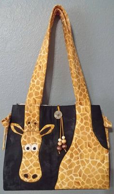 a giraffe bag hanging on the wall with it's face painted on