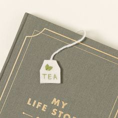 a book with a tag that says, my life story is tea written on it