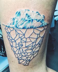 an iceberg tattoo on the leg