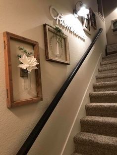 the stairs are decorated with flowers and framed pictures