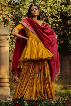 Mustard yellow peplum short tunic with floral motifs, dori work and gota embroidery. Comes with printed tiered gharara and contrast coin tassel  dupatta.
Component: 3
Embroidered, Printed
Neckine: Round
Sleeve Length: Half
Fabric: Silk Chanderi
Color: Yellow
Peplum tunic
Gathered flare
Tiered gharara - Aza Fashions Peplum Gharara, Punit Balana, Dori Work, Antique Gold Earrings, Short Tunic, Printed Kurti, Yellow Silk, Sharara Set, Designer Wear