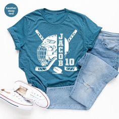 a t - shirt with the words jaloo on it next to jeans and sneakers