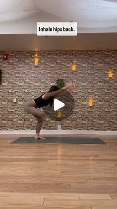 a woman standing on one leg in the middle of a yoga pose