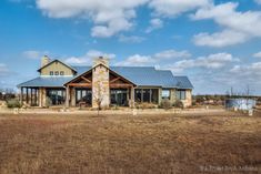 a large house sitting on top of a dry grass field