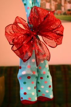 a pair of socks tied to a pole with a red bow on it and polka dots