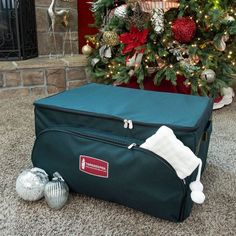 a christmas tree is in front of a suitcase