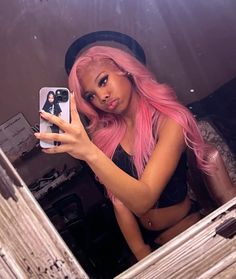 a woman with pink hair taking a selfie