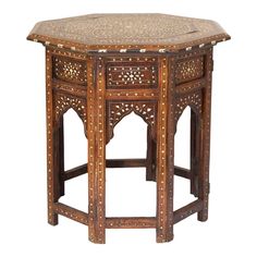 an old wooden table with intricate carvings on the top and sides, isolated against a white background