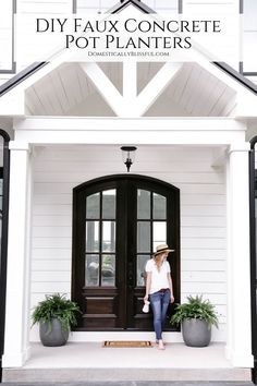 a woman standing in front of a black and white house with the words diy faux concrete pot planters