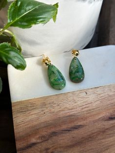 Beautiful emerald green colored earrings made from polymer clay, with small flecks of gold to give a perfect glimmer and shine. Hand painted gold on the edges. Incredibly deceivingly light weight. Each pair of earrings is made individually, thus each pair will be unique. Elegant Green Resin Jewelry, Green Resin Drop Earrings, Elegant Green Resin Earrings, Dark Green Drop Earrings For Gift, Green Jade Earrings For Pierced Ears, Dark Green Drop Earrings As Gift, Irish Earrings, Celtic Green, Colored Earrings