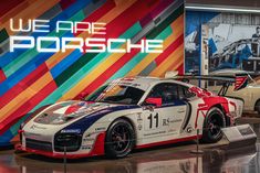 two race cars are on display in front of a colorful wall that says we are porsche