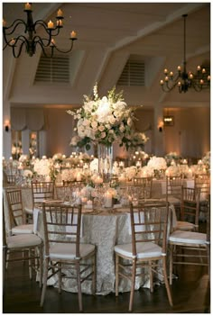 the tables are set with white flowers and candles