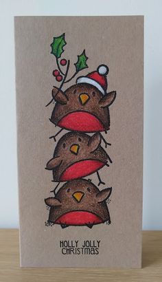 a christmas card with three brown bears wearing hats and holly decorations on top of each other