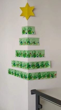 a christmas tree made out of handprinted paper